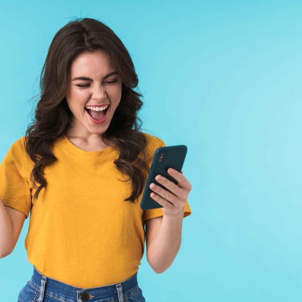 Young woman on smartphone is happy