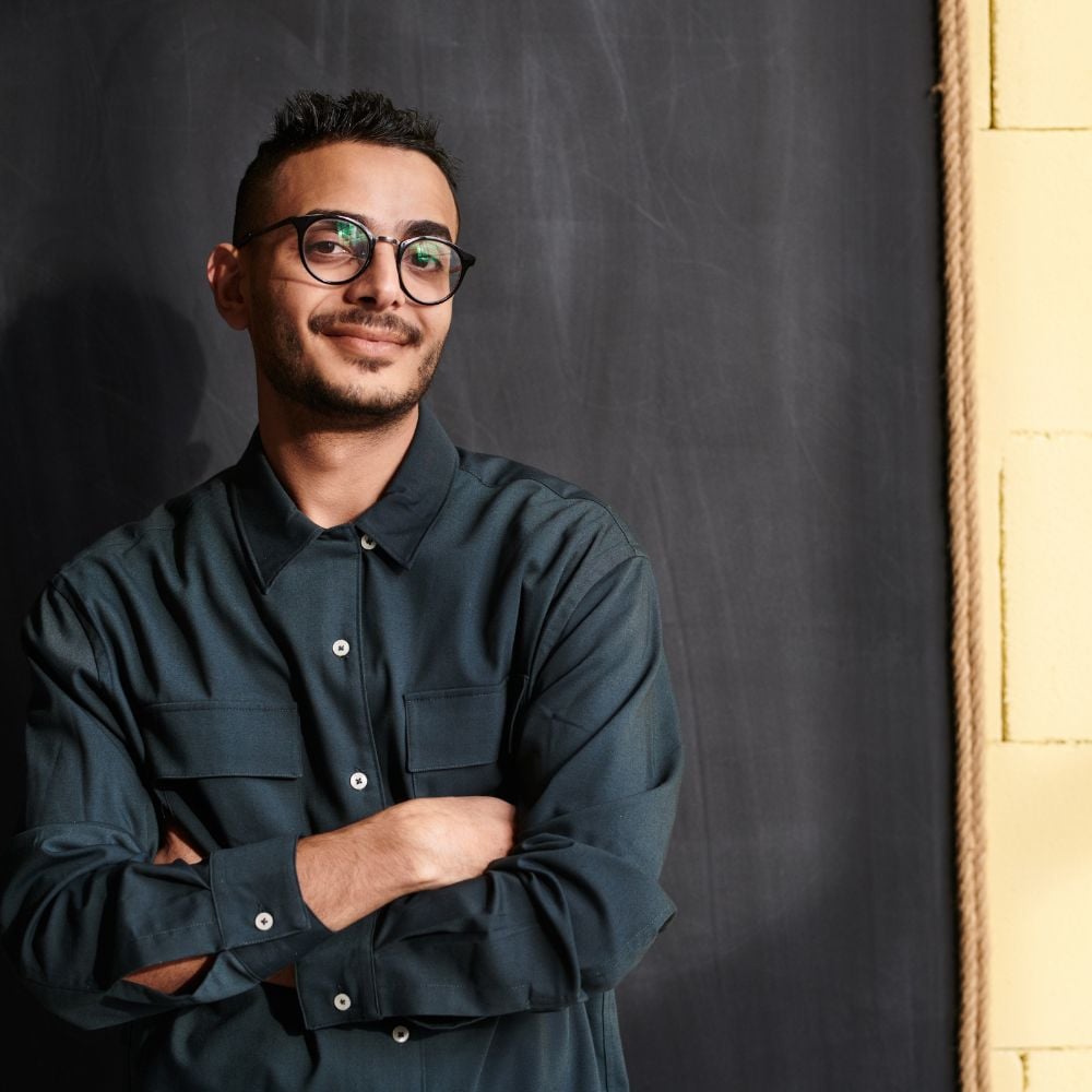 Student with glasses in black shirt