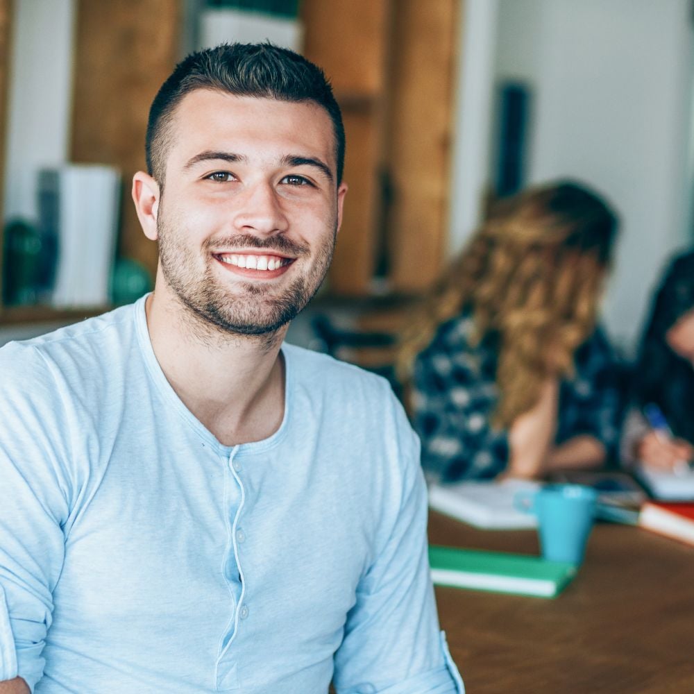 Student in white shirt laughing