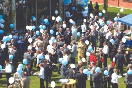 People with colourful balloons on the campus grounds