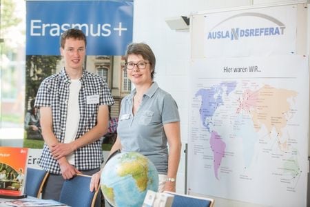 Student and employee smiling at camera