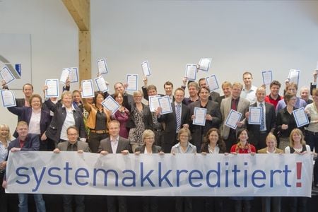 Various people holding a sign and documents to the camera