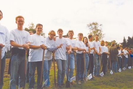 A row of people with spades in their hands